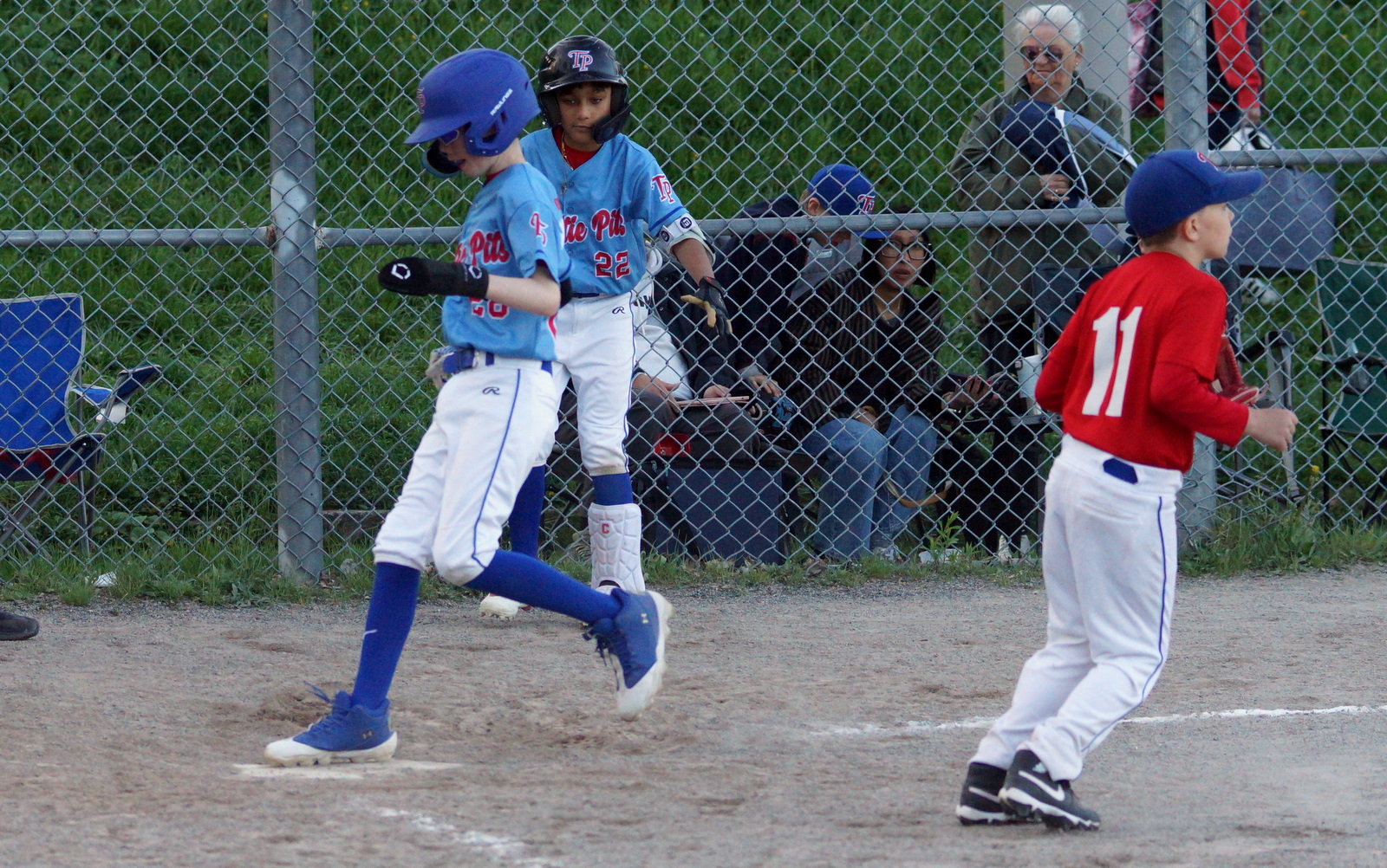 Taking advantage of a TP 10U 'AA' wild pitch, TP 11U baserunner Ben (28) hustles home with a run in the bottom of the fourth inning.