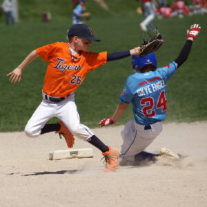 TP 11U 'A' baserunner Milo (24) slides by Peterborough 11U 'A' shortstop Fynn (26) for a deft theft of second base in the bottom of the sixth inning.