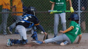 GRAND THEFT &gt; As the throw sails away from White Sox catcher Sid (13) [left], A's baserunner Liam (7) [right] completes a brazen steal of home in the bottom half of the third inning to stake the A's to a 6-3 lead during a 2025 TPBA House League Tournament 11U Mosquito Division Round Robin Game at Christie Pits Diamond 3.