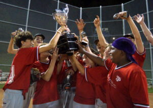 Following their marathon 17-15 double extra inning victory over the Buckeyes, a jubilant group of Eagles players hoist the TPBA House League Tournament 15U Bantam  Division Championship Trophy at Dominico Field at Christie Pits.