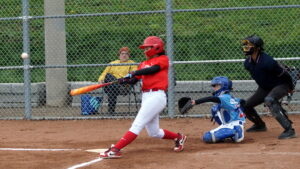 MOONSHOT > With a majestic swing, Sienna (27) launches a two out two run master blaster home run blast over the tall chain linked fence in the left-centre field.