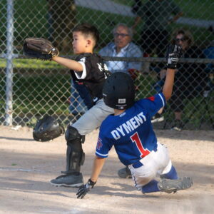 With flair, TP 9U baserunner Austin (1) scores a stylistic run for TP 9U in the fourth frame.