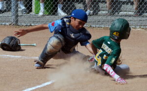 In a chitty chitty bang bang play, TP 12U 'A' catcher Nolan (22) tags out York 12U 'A' baserunner Rayn (42) on an exquisite 1-2 defensive play at home plate in the third inning.