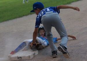 By his chinny chin chin, TP 10U 'A' baserunner Archie (1) beats the tag of North York 10U 'A' third baseman Ethan (27) to complete a down and dirty steal of third in the fifth inning.