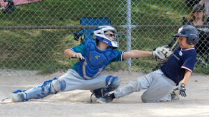 After taking the laser throw from his centre fielder [Zev (3)], Rays catcher tags out Lizzies baserunner Sam (1) to ring up a chitty chitty bang 8-2 double play during a 2026 TPBA House League Baseball 11U Mosquito Division Tournament Quarter-Final Game at Christie Pits Diamond 3.